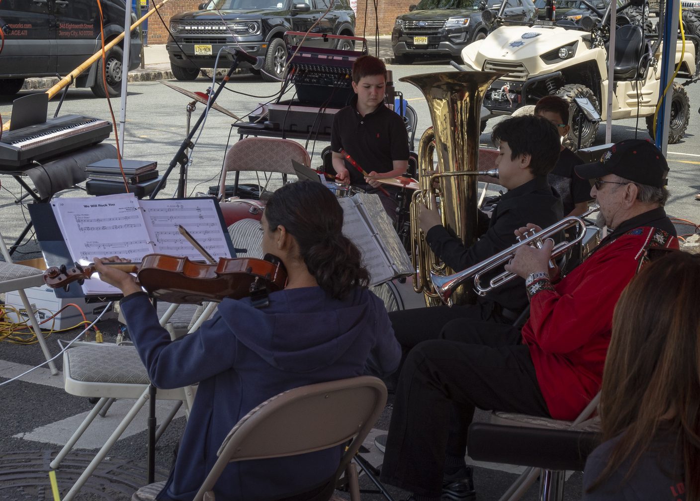 NJWA volunteers and student musicians performing together at an outdoor community event