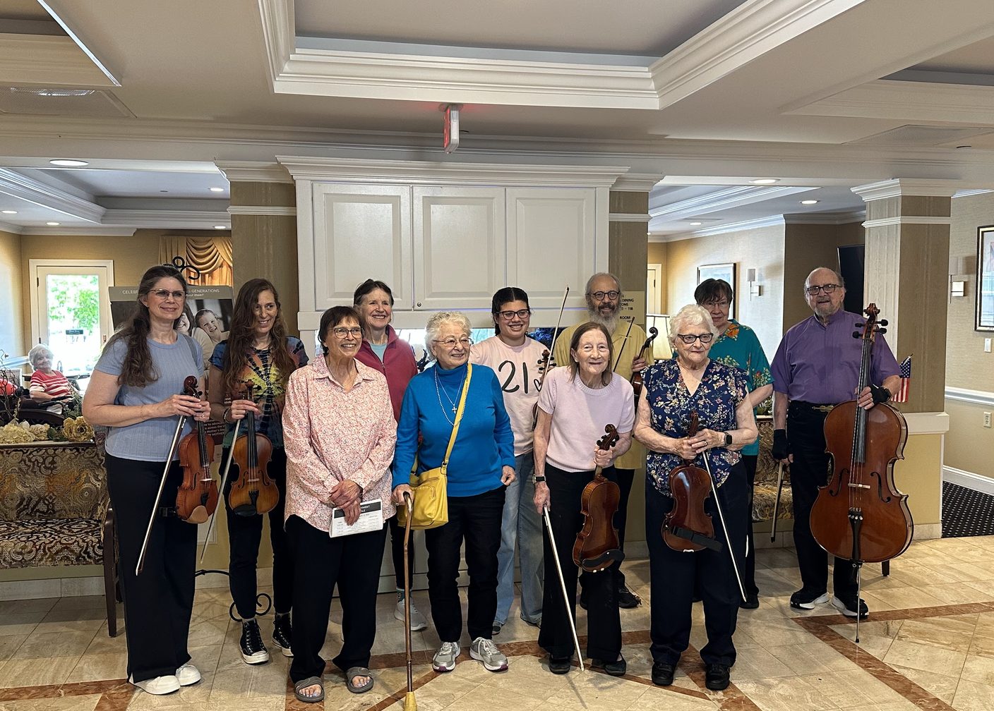 The Wednesday Morning Strings adult ensemble posing with their instruments