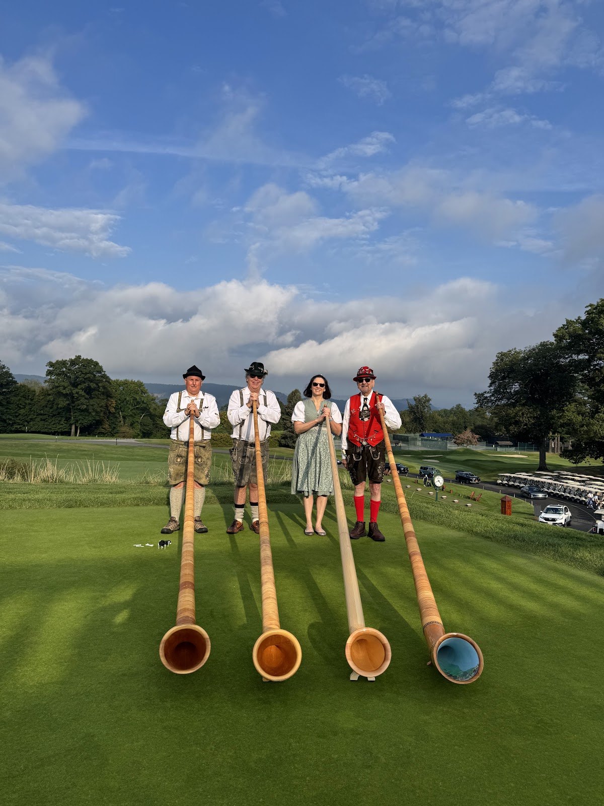 Members of the NJWA Alphorn Ensemble standing with their alphorns on a lawn