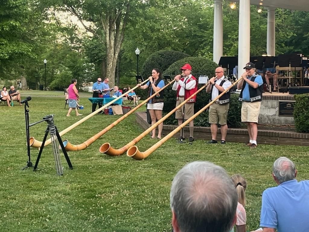 The Alphorn Ensemble playing in a park at a community event