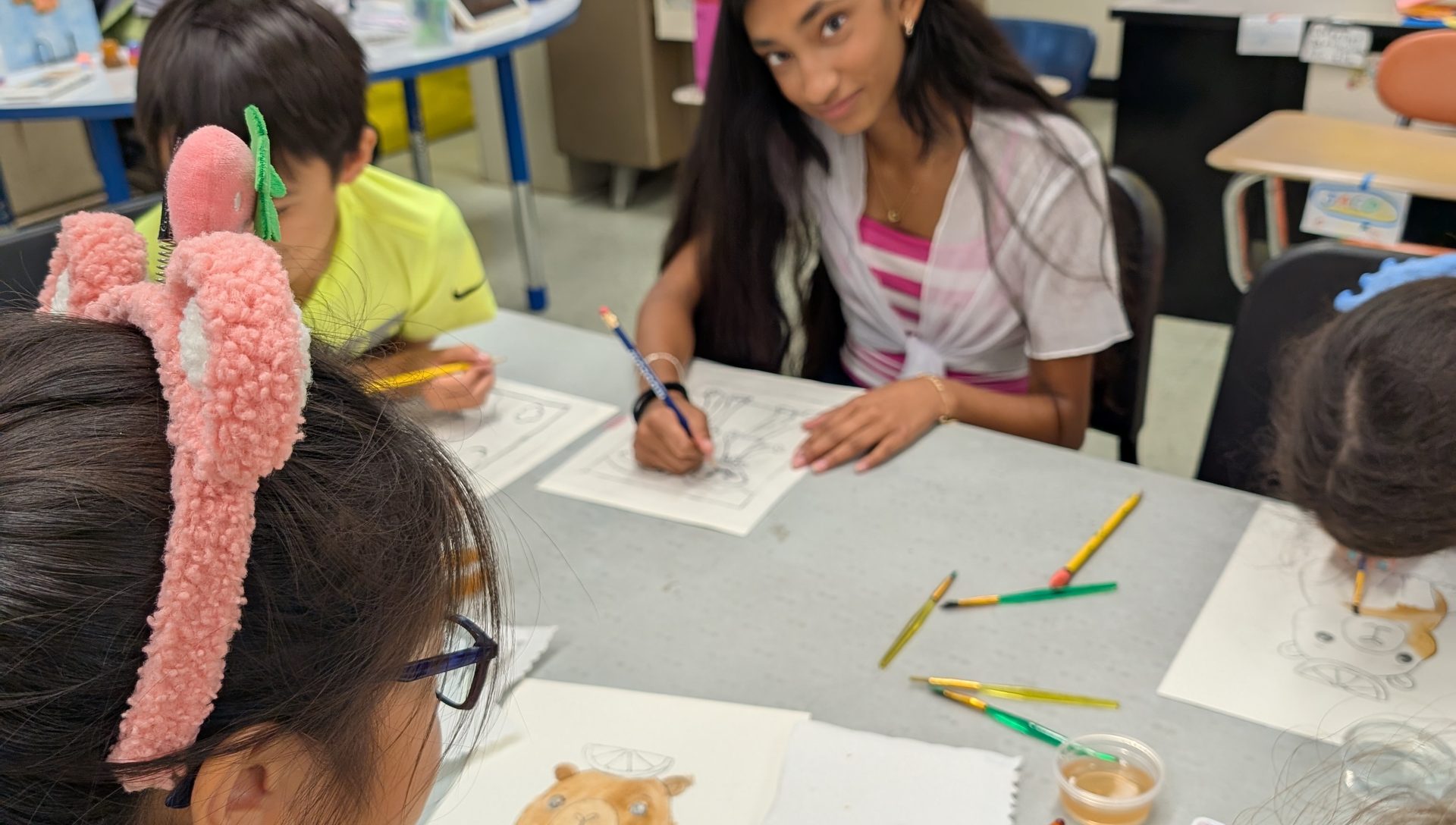 Students drawing together at an NJWA art table