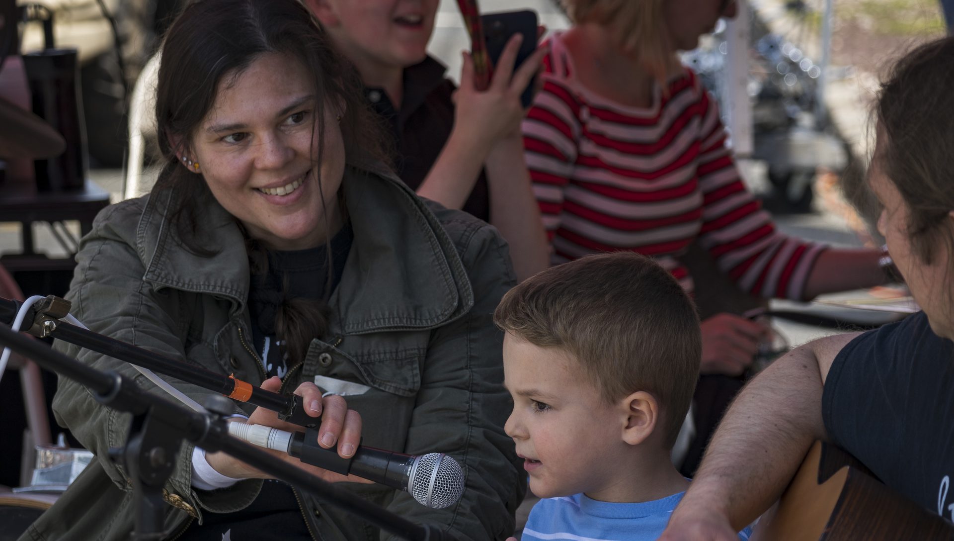 A young child singing into a microphone at an NJWA performance